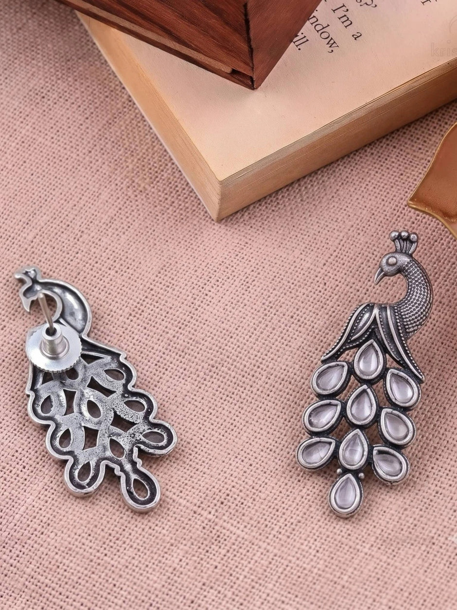 Front and back view of oxidised silver peacock earring showing push-back closure and hollow reverse detail