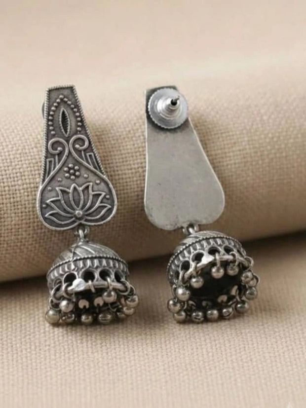 Front and back view of oxidised silver lotus jhumka earrings showing engraved panel and push-back stud fitting