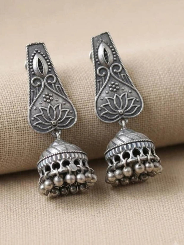 Pair of oxidised silver lotus jhumka earrings displayed side by side showing full engraved detail and bead fringe