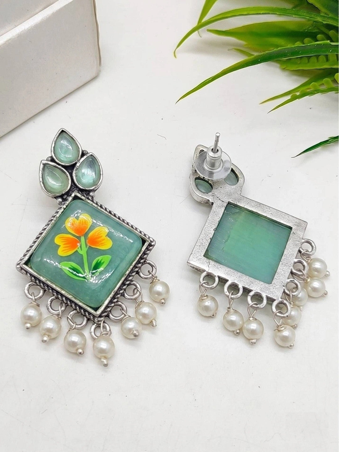 Front and back view of minakari drop earrings showing push-back stud post and green enamel reverse