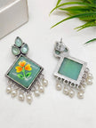 Front and back view of minakari drop earrings showing push-back stud post and green enamel reverse
