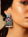 Oxidised silver floral jhumka earring worn on a woman's ear, showing crystal top and pearl drops