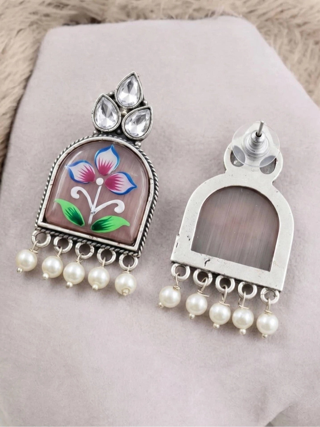 Front and back view of oxidised silver jhumka earring showing stud fitting and open arch frame