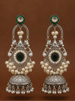 Pair of oxidised silver chandbali jhumka earrings with green kundan tops displayed against warm brown background