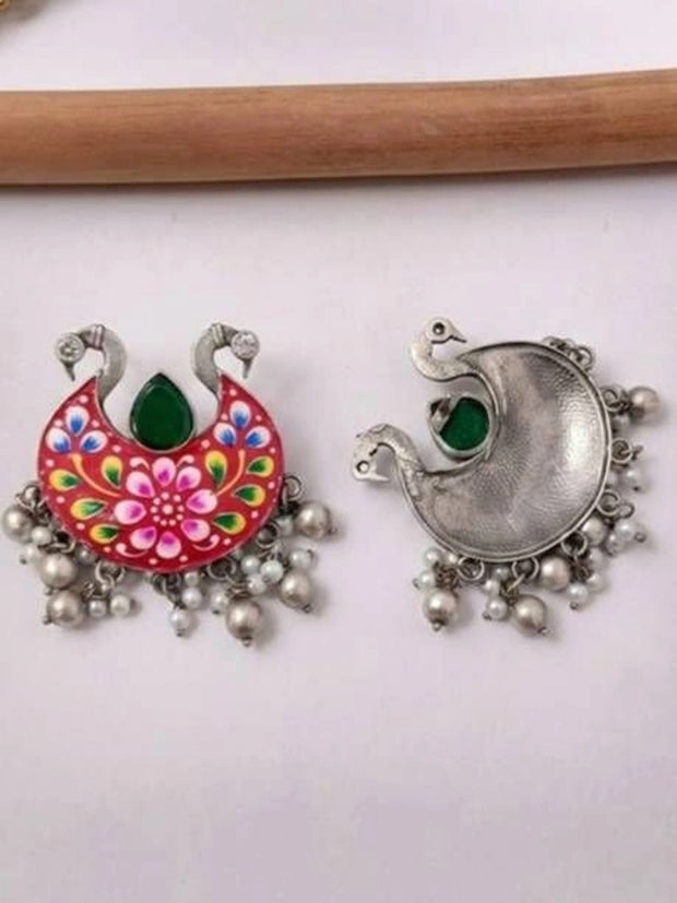 Front and back view of red meenakari chandbali earring on white surface