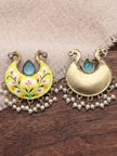 Front and back view of yellow meenakari chandbali earrings with pearl drops on a wooden surface