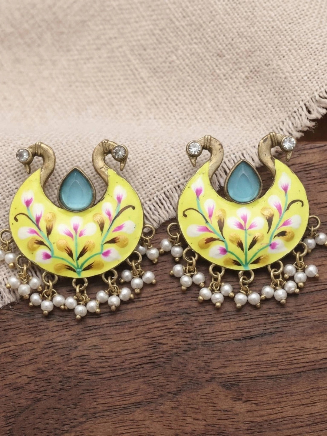 Pair of yellow hand-painted meenakari chandbali earrings with turquoise stone and white pearl drops