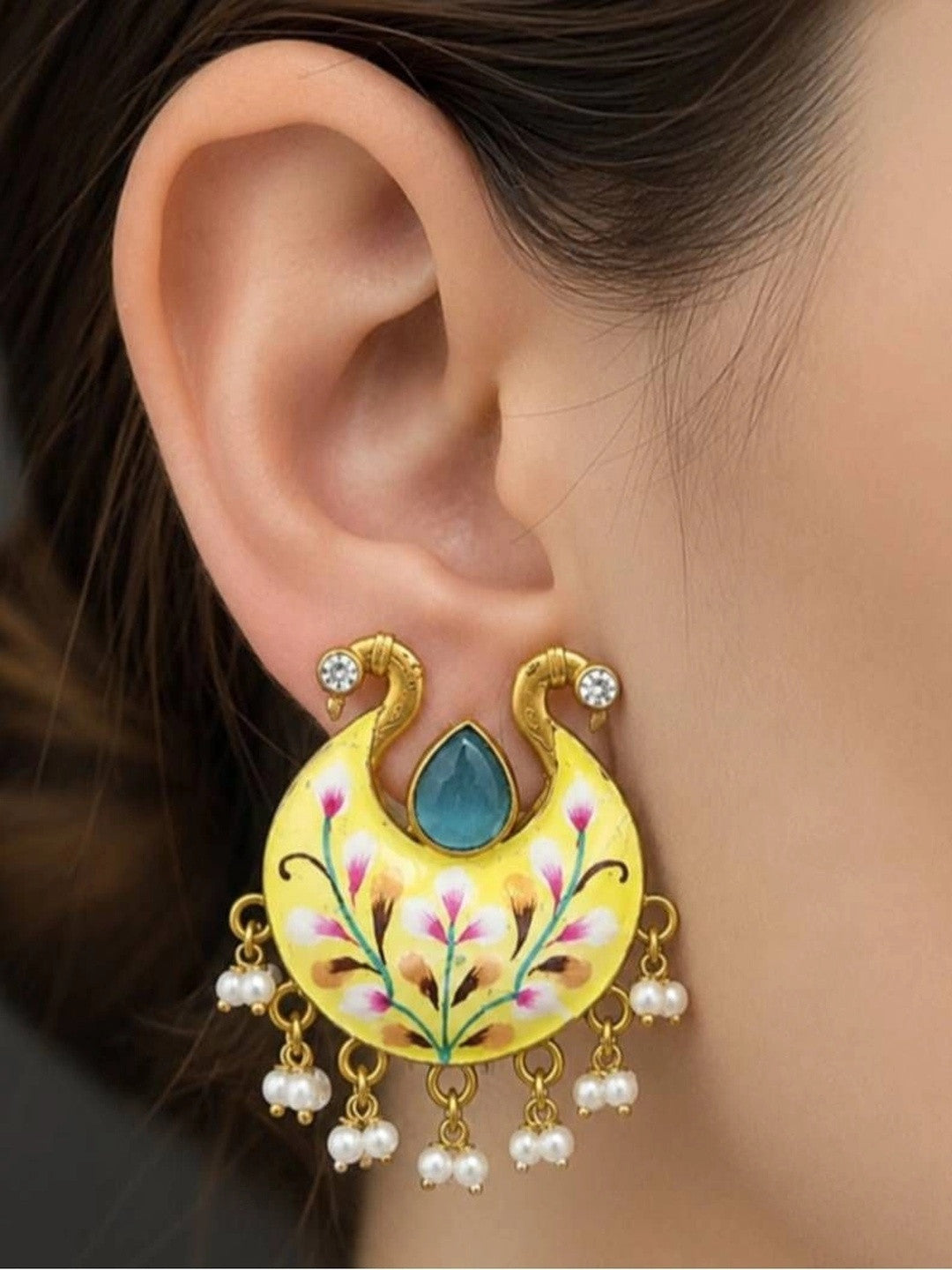 Yellow meenakari chandbali earring worn on a woman's ear showing size and drape