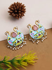 Both meenakari peacock chandbali earrings displayed flat on a gold surface