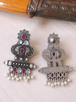 Front and back of oxidised silver chandbali earring pair laid flat on white surface