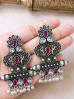 Both oxidised silver chandbali earrings held in an open palm showing full design and pearl drop fringe