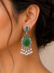 Oxidised silver chandbali earring with hexagonal green stone and pearl drops worn on model's ear