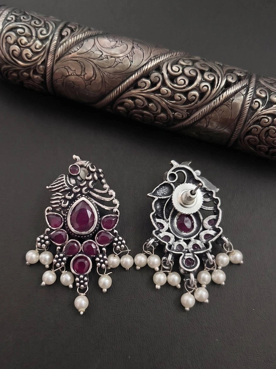 Front and back view of oxidised silver peacock earrings showing hook and reverse detail