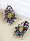 Two oxidised silver peacock earrings laid flat, front and back views, on a cream surface