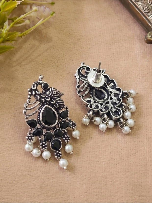 Front and back view of oxidised silver peacock earrings showing stud fitting and pearl drops