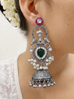 Single oxidised silver chandbali jhumka earring worn on a woman's ear showing full length from pink kundan stud to ghungroo drops
