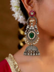 Oxidised silver teardrop jhumka earring worn by a woman in a red saree with white flowers in her hair