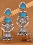 Two jhumka earrings propped against a wooden stick showing full layered drop design