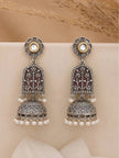 Oxidised silver lotus jhumka earring pair displayed upright on white fabric with pampas grass background