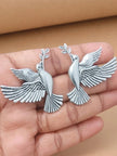 Pair of oxidised silver dove stud earrings with olive branch held in open palm