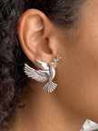 Oxidised silver dove stud earring worn on a woman's ear showing scale and fit