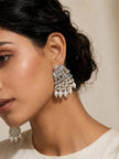 Model wearing oxidised silver elephant earring with cascading faux pearl drops against a neutral background