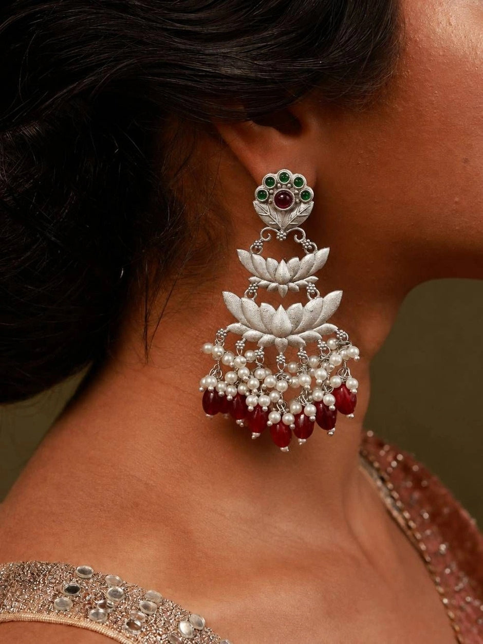 Oxidised silver lotus chandbali earring worn on ear with pearl and red bead drops