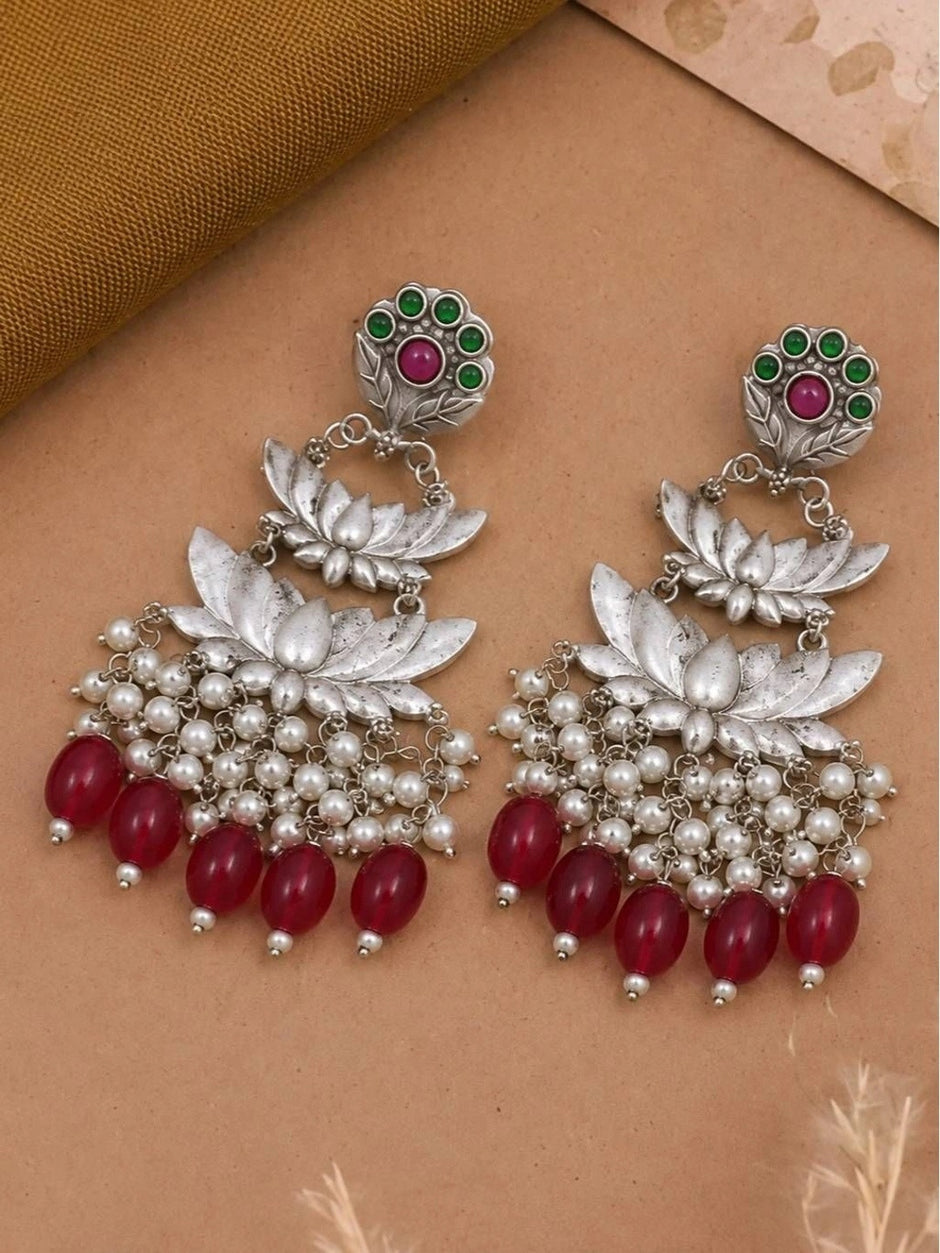 Pair of oxidised silver lotus chandbali earrings laid flat showing front detail
