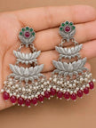 Pair of lotus chandbali earrings held in palm showing full length pearl and red drop fringe