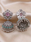 Front and back view of oxidised silver jhumka earrings on cream fabric showing scrollwork stud and pearl drop hem