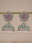 Pair of oxidised silver elephant jhumka earrings hanging from a gold rod showing full silhouette with pearl drop fringe