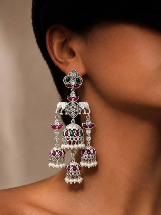Oxidised silver elephant jhumka earring worn on model's ear showing triple-tier drop with pearl fringe