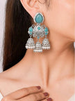 Oxidised silver triple jhumka earring with turquoise stones worn on a model's ear