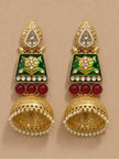 Both jhumka earrings laid flat on a beige surface, displaying leaf stud tops, green enamel panels and lattice dome bells