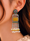 Oxidised silver chandbali earring worn on ear showing green flower stud, peacock motif, yellow stone and pearl drop dangles