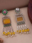Front and reverse side of oxidised silver chandbali earrings showing push-back stud and plain back of yellow stone frame