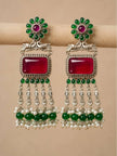 Pair of oxidised silver chandbali earrings displayed on fabric roll showing full tassel length
