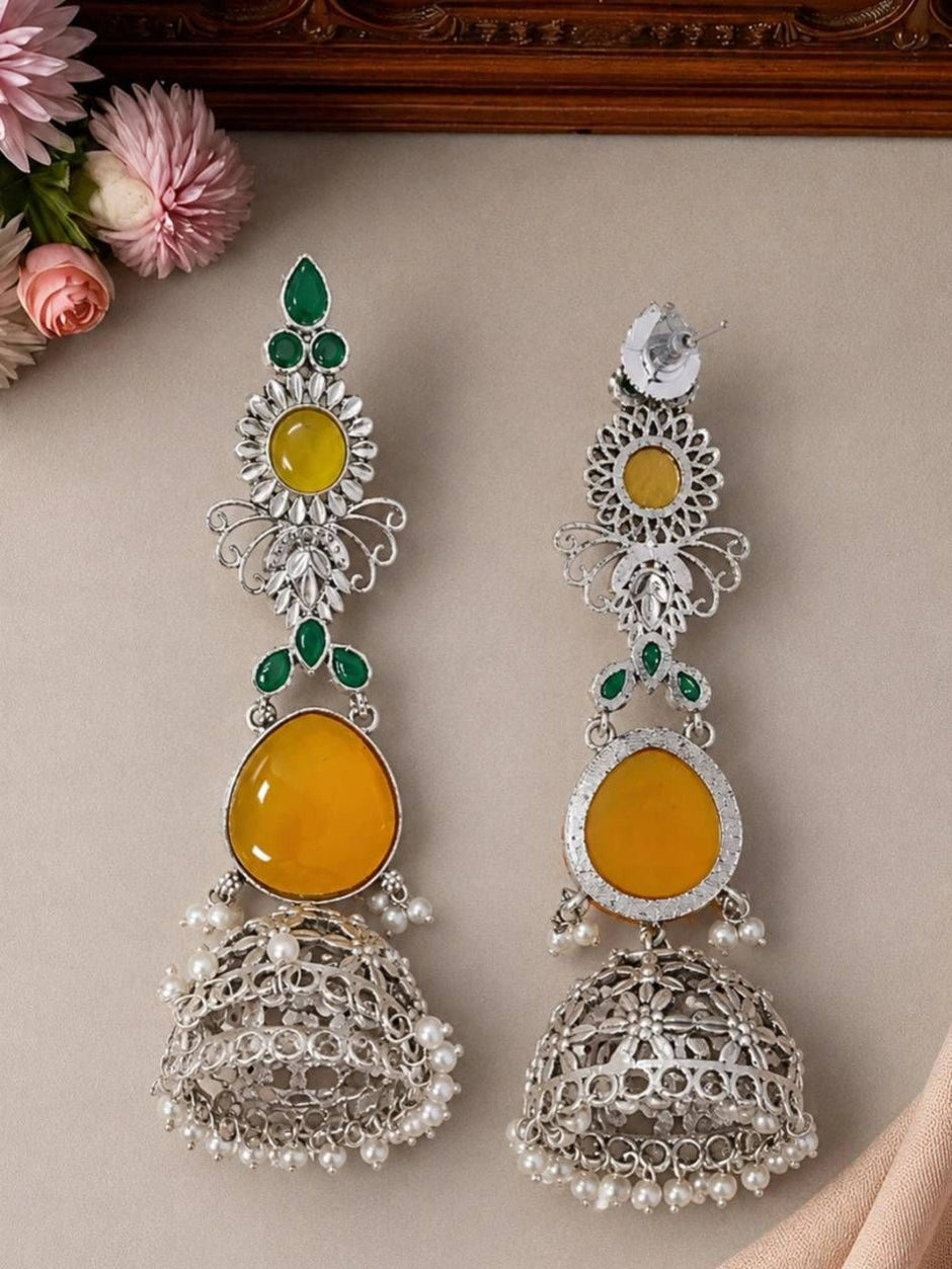 Front and back view of oxidised silver jhumka earring showing stud back and filigree bell with pearl drops