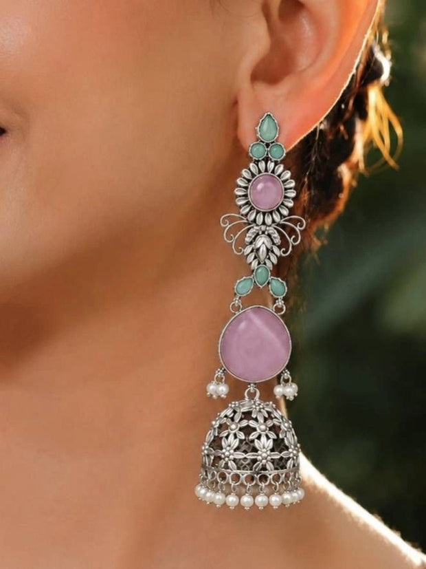 Oxidised silver long jhumka earring with pink stone and mint drops worn on ear