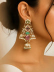 Gold-plated kundan jhumka earring worn on model's ear showing full layered design with pearl borders and pink stone