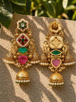 Front and back view of one kundan jhumka earring side by side showing reverse gold-tone engraved detail