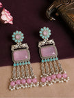 Pair of oxidised silver chandbali earrings with peacock motif and pink pearl cluster tassels on a dark maroon background with roses