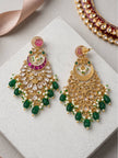 Kundan chandbali earring pair on white surface showing front and reverse sides revealing gold filigree framework and green melon-cut bead drops
