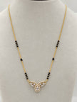 Gold-plated mangalsutra with CZ pear pendant and black beads displayed on a white jewellery bust