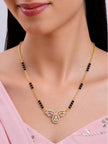 Model wearing gold-plated CZ mangalsutra over a pink ethnic top showing pendant at collarbone
