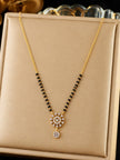 Gold-plated CZ mangalsutra with black bead strands and sunburst pendant displayed on a beige jewellery box