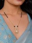 Woman wearing gold-plated CZ mangalsutra over a light blue embroidered saree