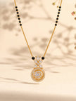 Close-up of CZ mangalsutra pendant with floral cluster and circular motif on a beige background