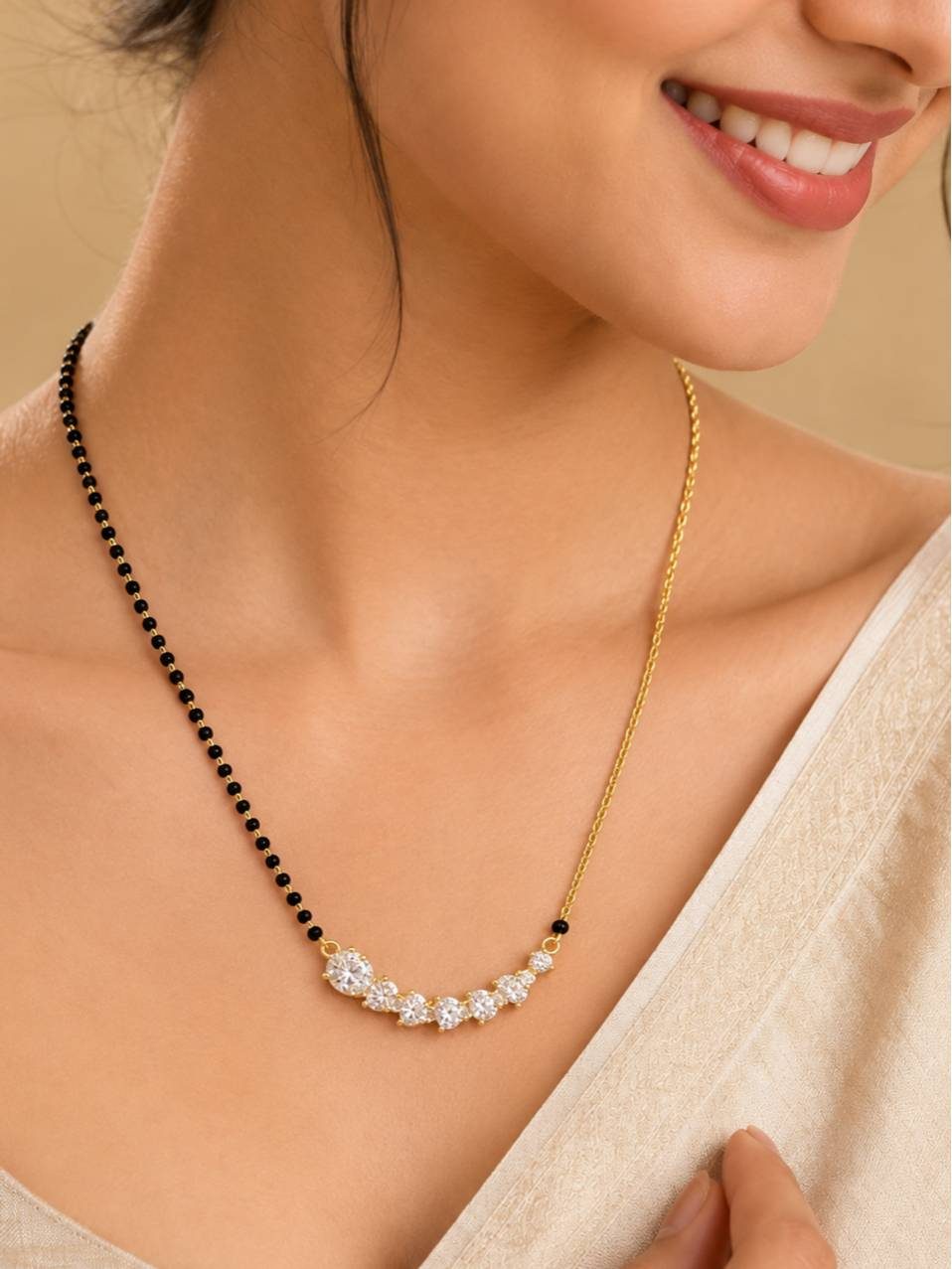 Woman wearing gold-plated CZ mangalsutra over a saree, smiling with collarbone visible