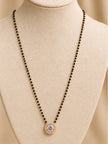 Gold-plated CZ solitaire mangalsutra with black bead chain displayed on a cream jewellery bust
